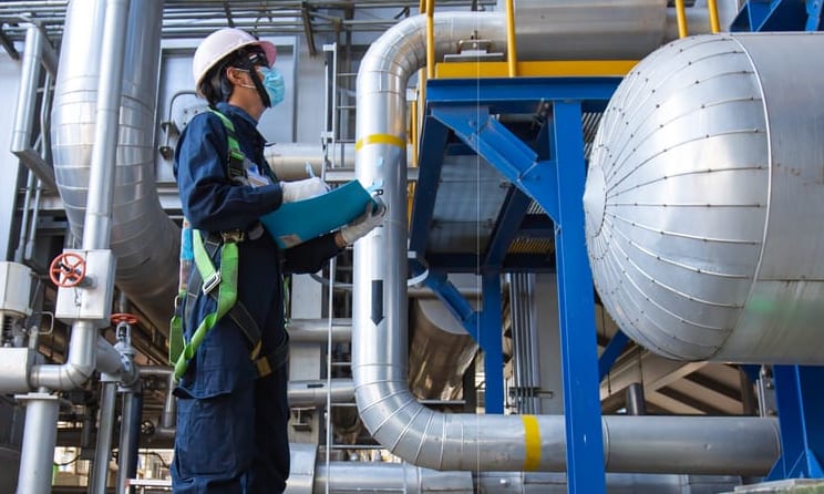 Engineer checking process equipment